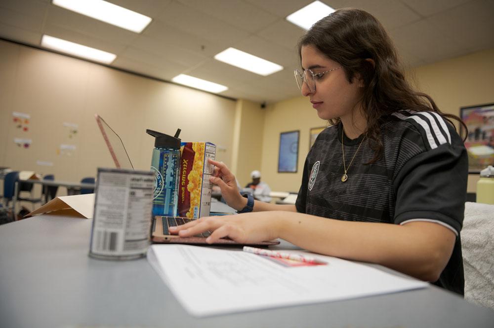 A student examines nutrition information in the Burkhiser Complex